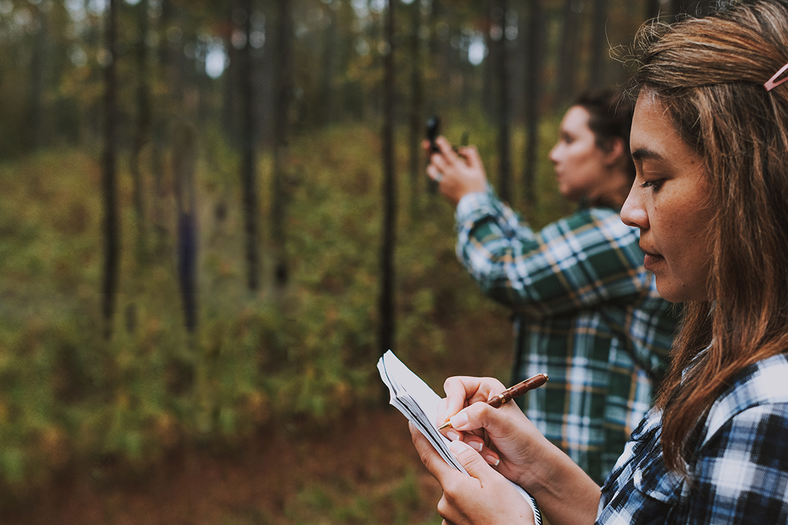 students taking notes and measuring trees