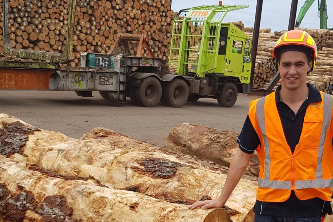 Forester standing in log yard