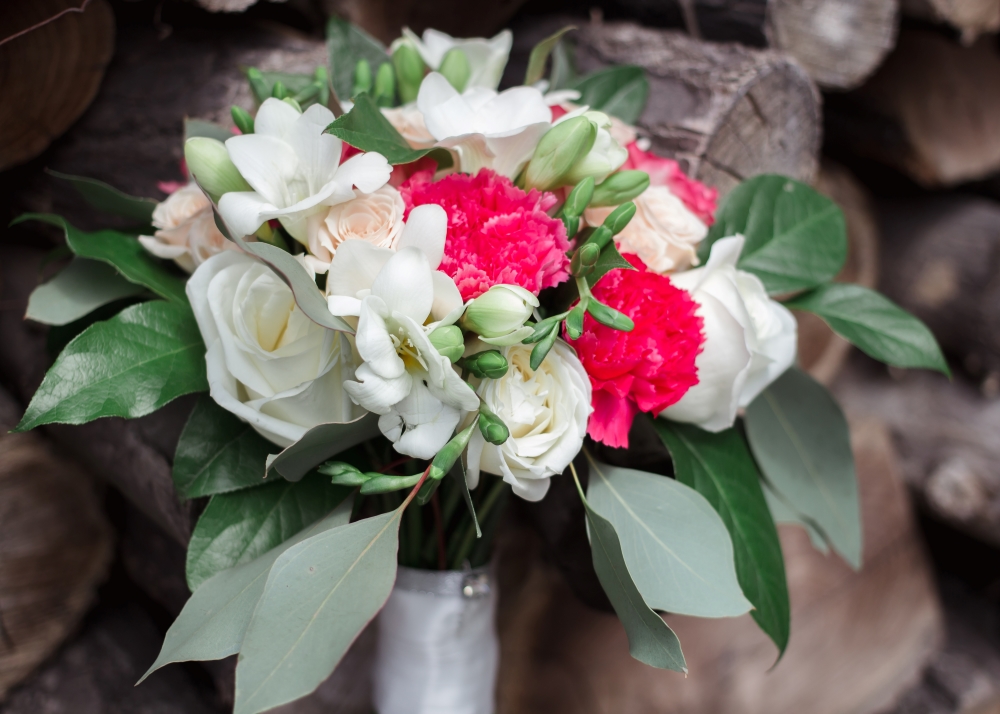 Flower bouquet with salal and a wood background